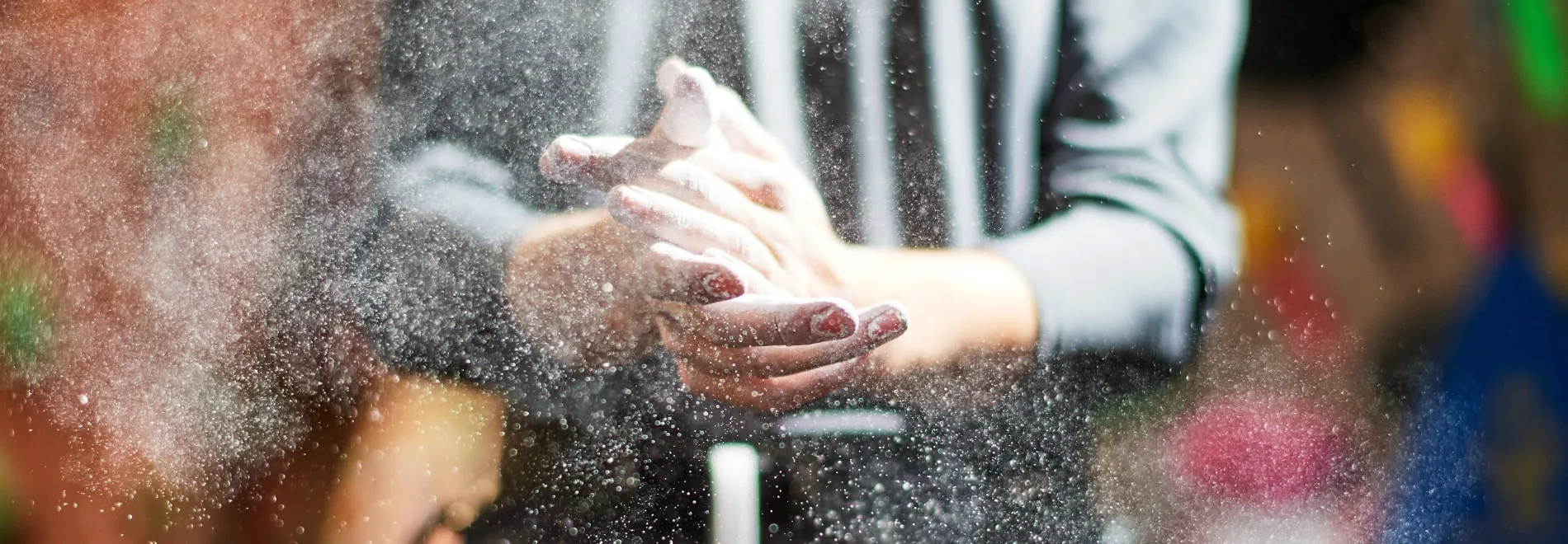 A climber chalking their hands before a climb