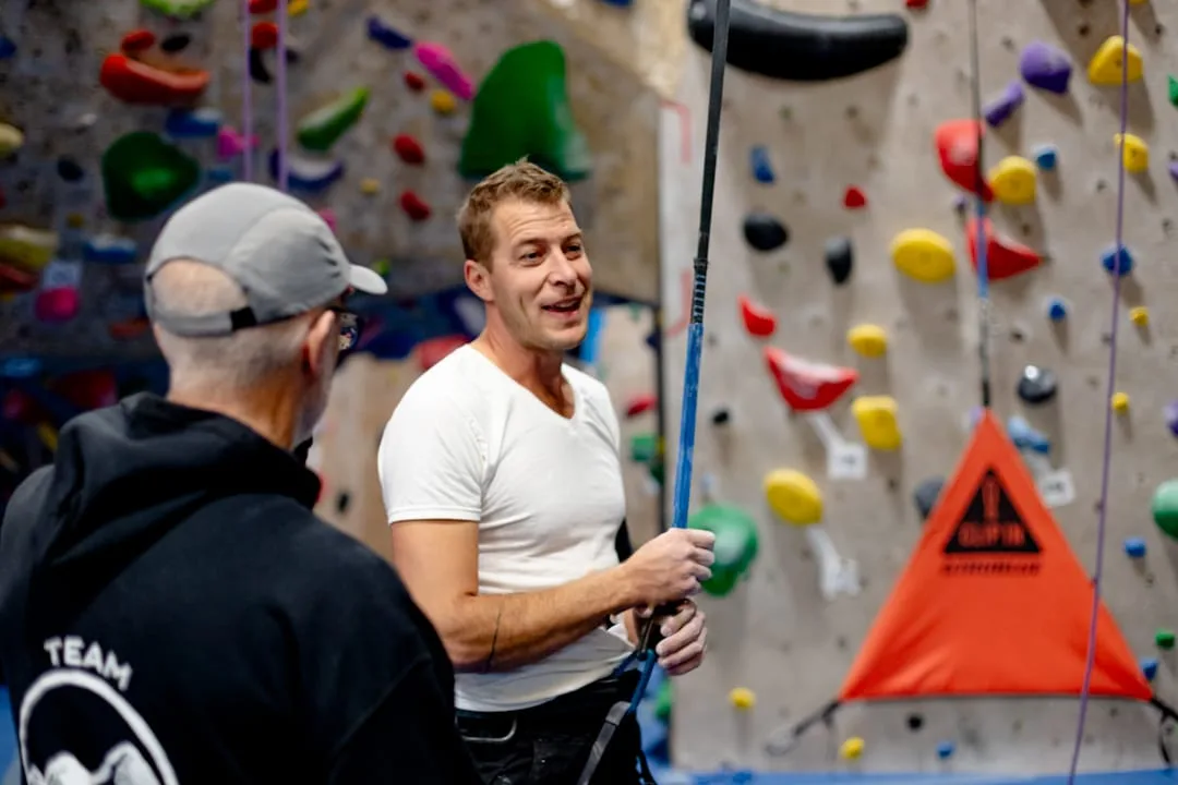 Climbers and coaches beside the rope walls at Vertex Climbing Center